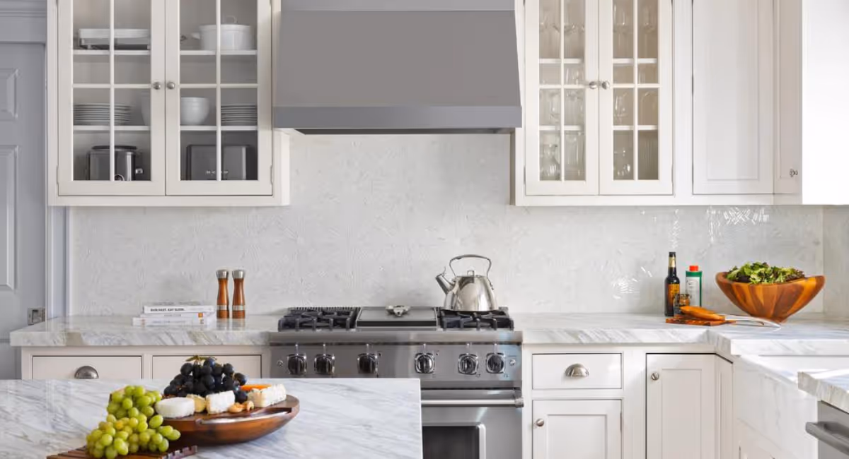 Stacy Nicole Interiors elegantly designed kitchen with a stove top oven and a bowl of food on the counter. Luxury interior design in Charlotte-based at 1515 Mockingbird Lane, Suite 420, Charlotte, NC 28209.
