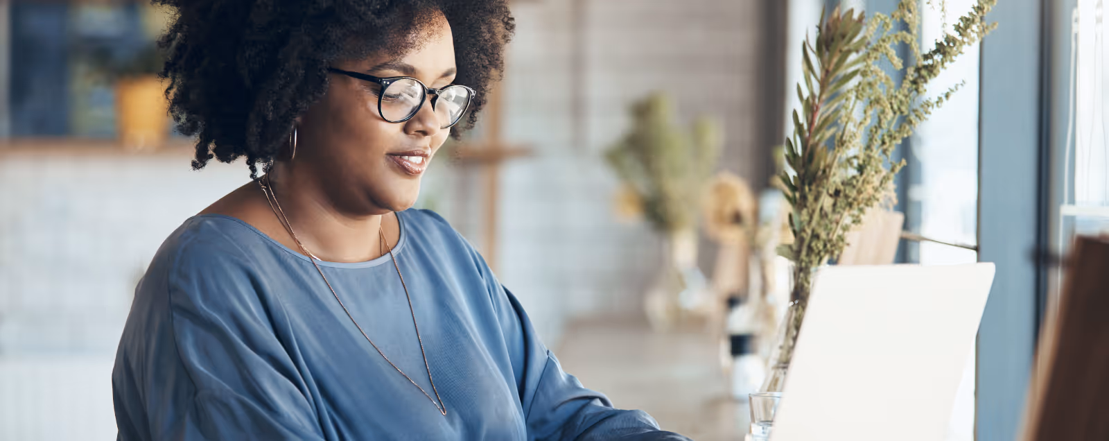 Nicole S. Ingram, CEO + Principal Designer at Stacy Nicole Interiors, is wearing glasses and a blue shirt.  Stacy Nicole Interiors is a full-service North Carolina interior design firm. Weddington interior designer.