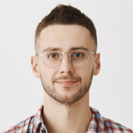 A man wearing glasses and a plaid shirt.