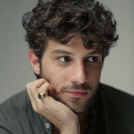 A close up of a person wearing a ring.