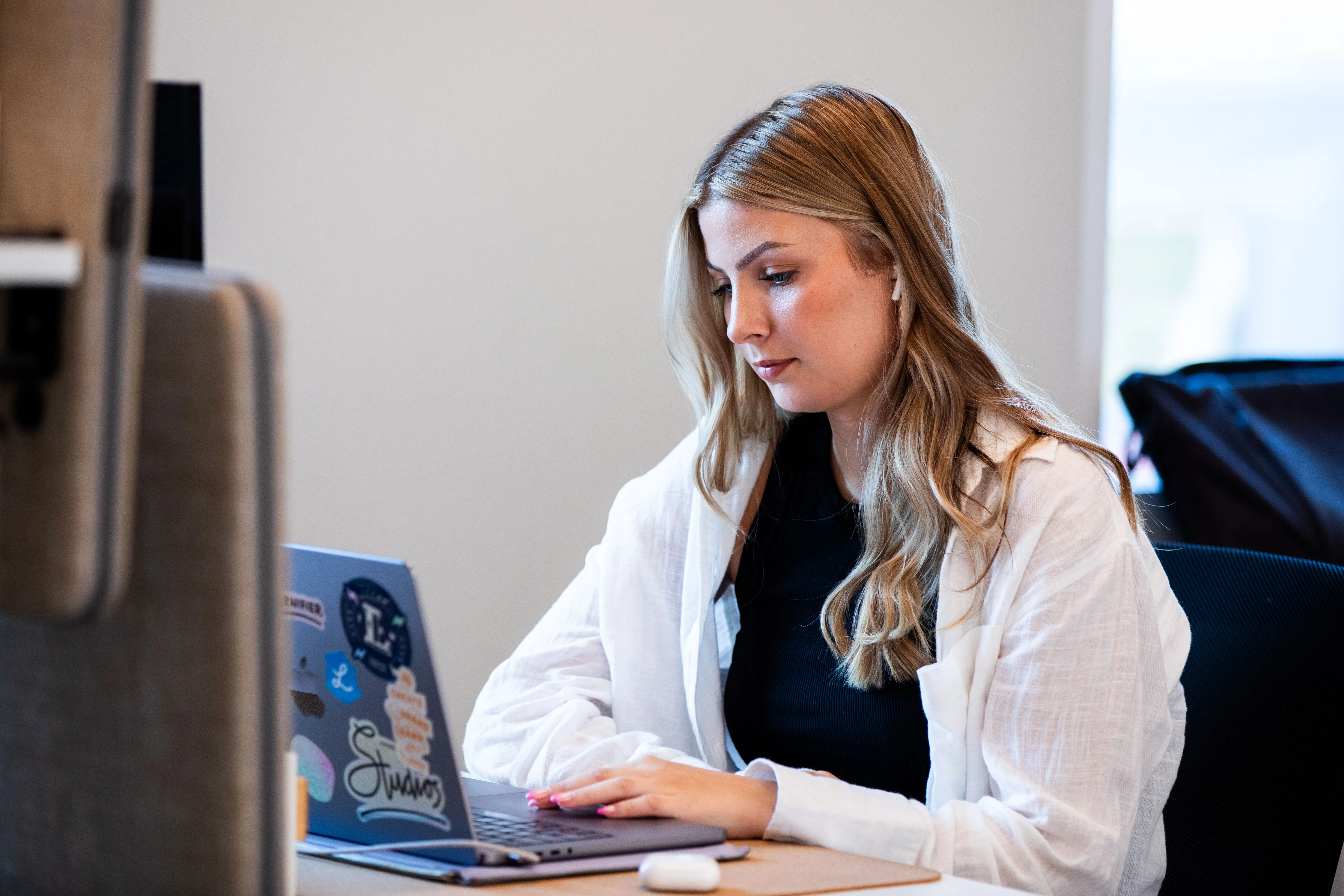 Employee working on her laptop at a desk