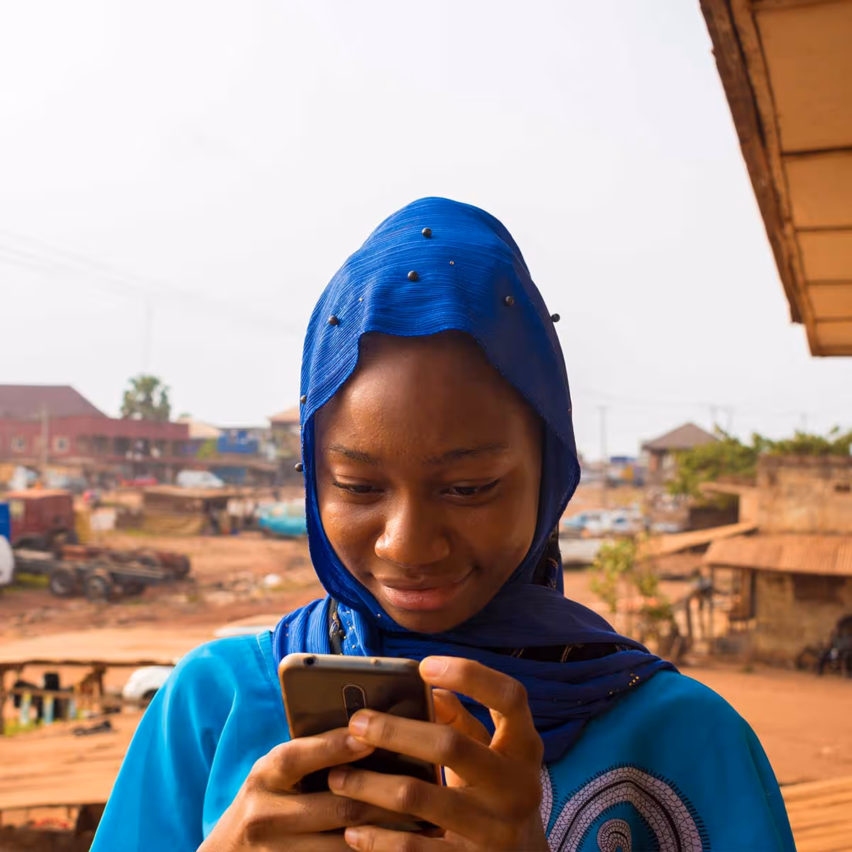 A woman looking at her phone and smiling 