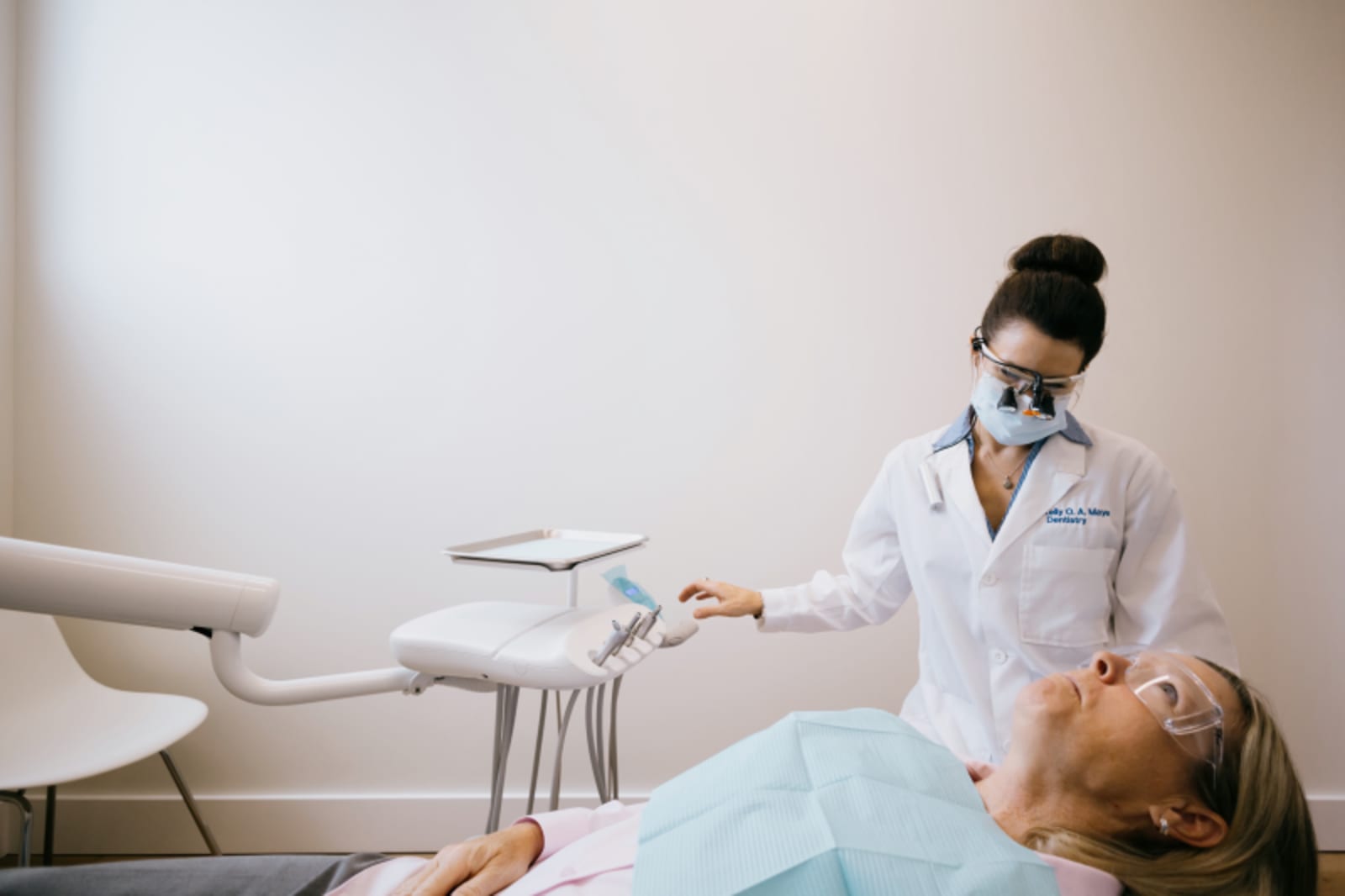 Dental professional preparing patient for procedure in clinical setting