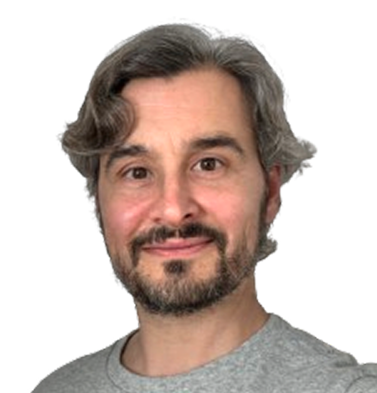 Man with gray hair and beard smiling slightly wearing a gray shirt with black background removed.