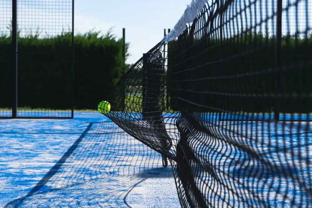Ball hitting the padel tennis net