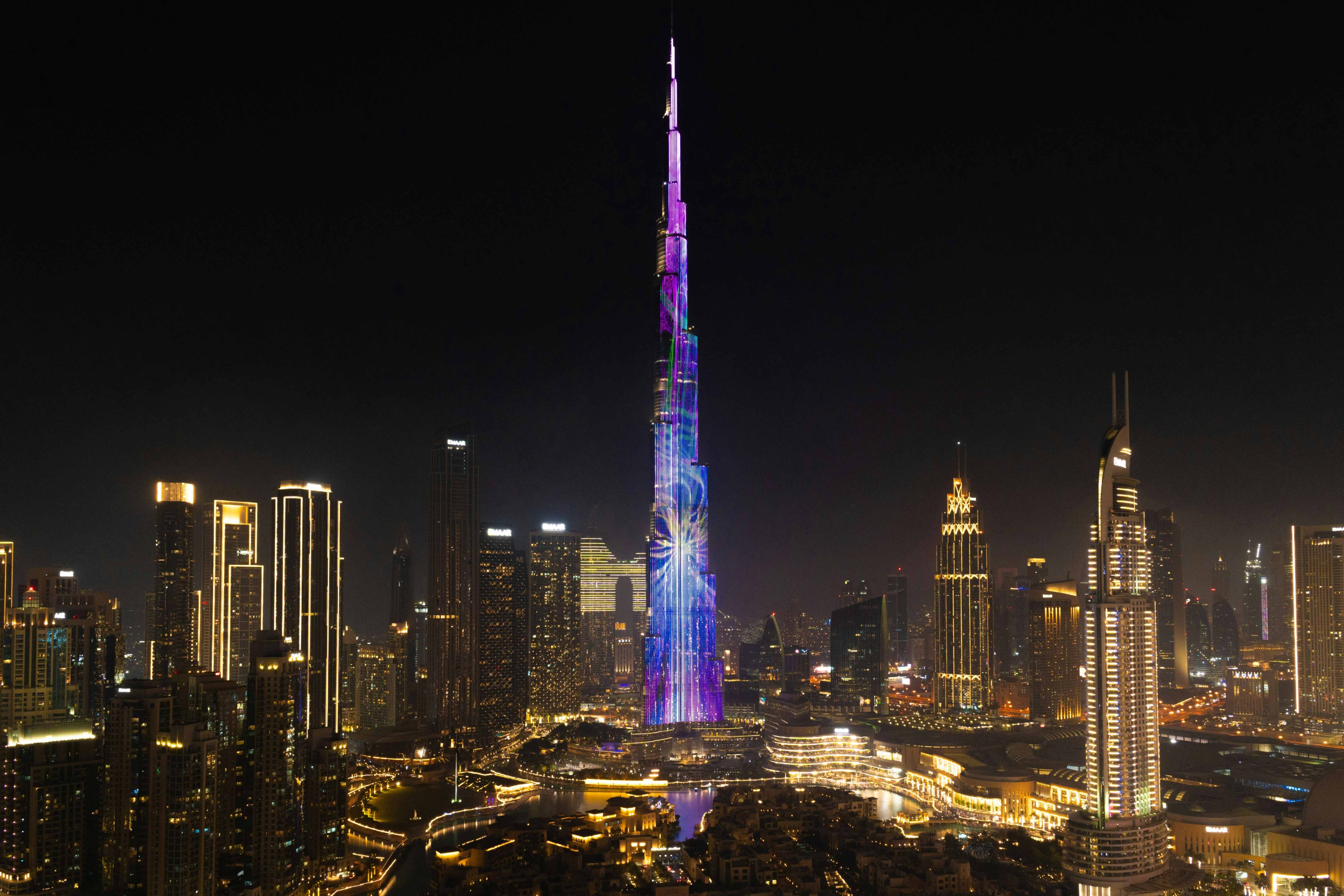 Dubai skyline at night with the illuminated Burj Khalifa, representing luxury real estate offerings from Westin Arabia
