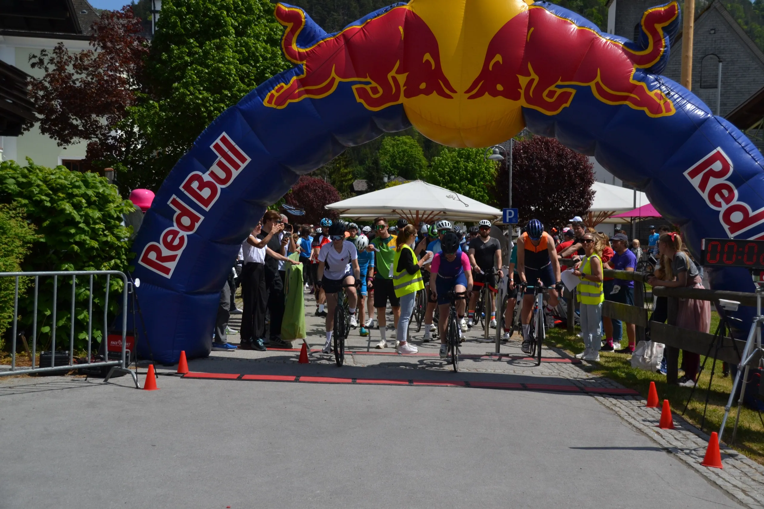 Cyclists starting the 2026 RISK MAN race beneath the start arch