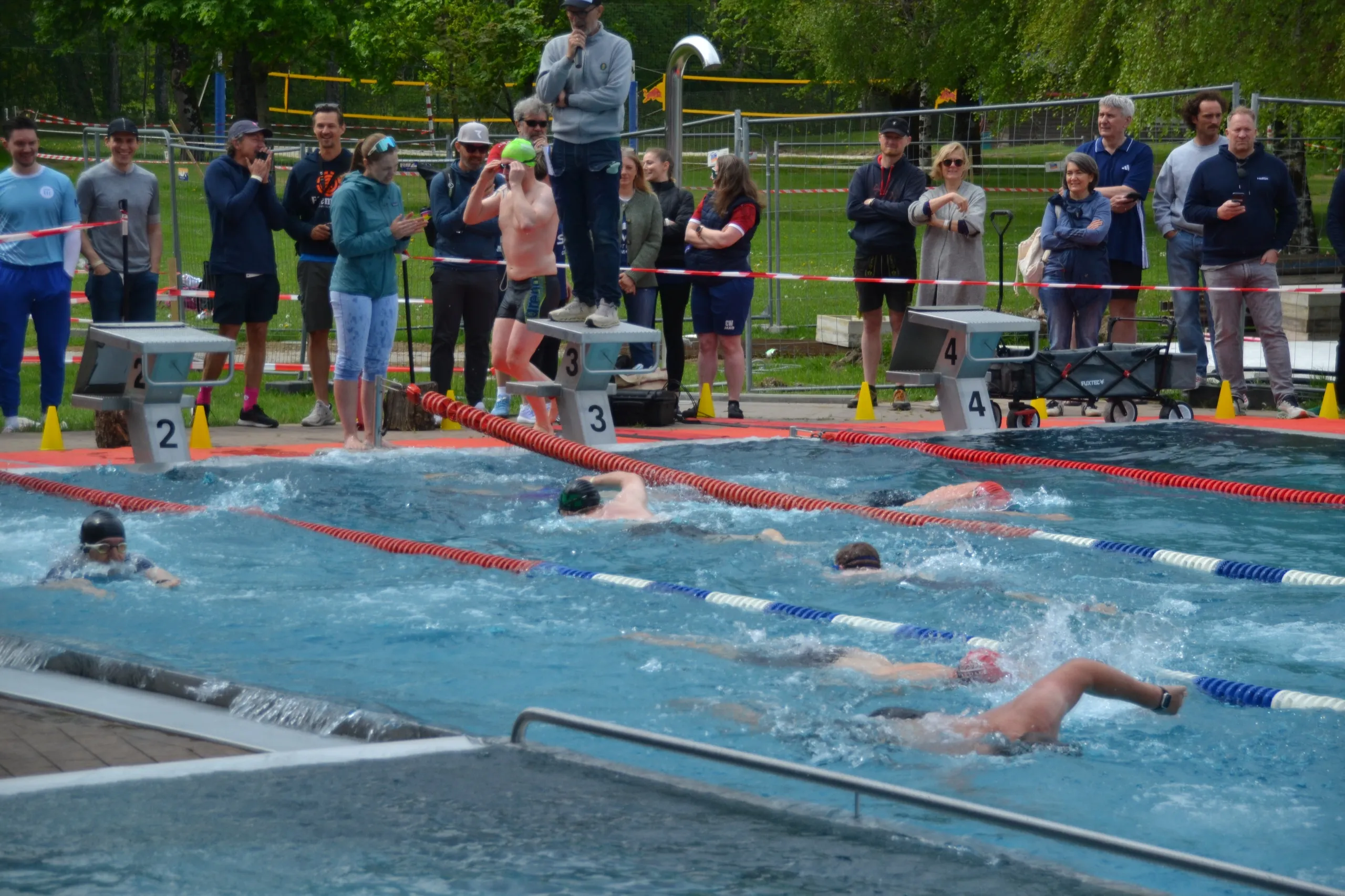 Swimmers racing in the 2026 RISK MAN pool event