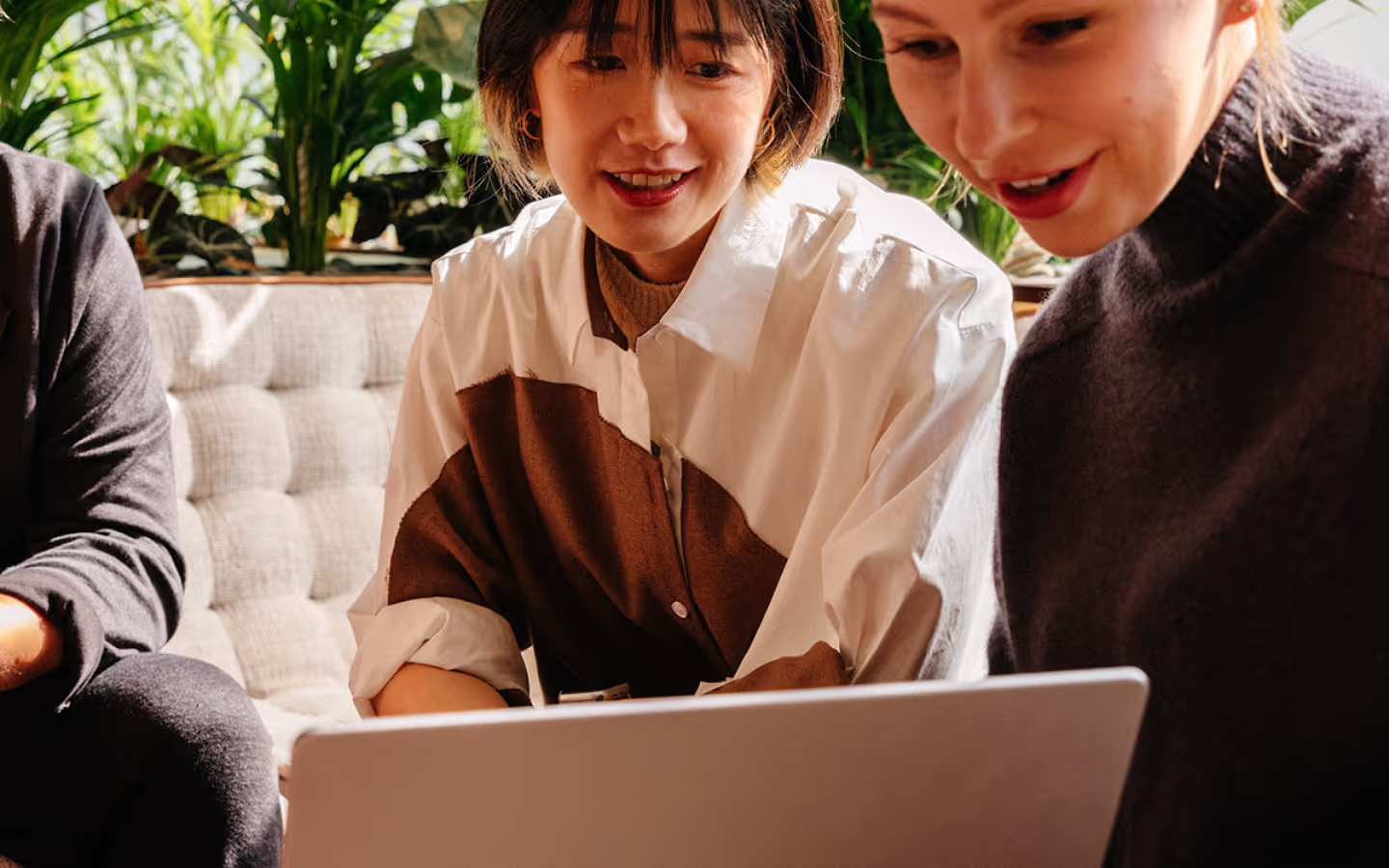 three people looking at laptop screen