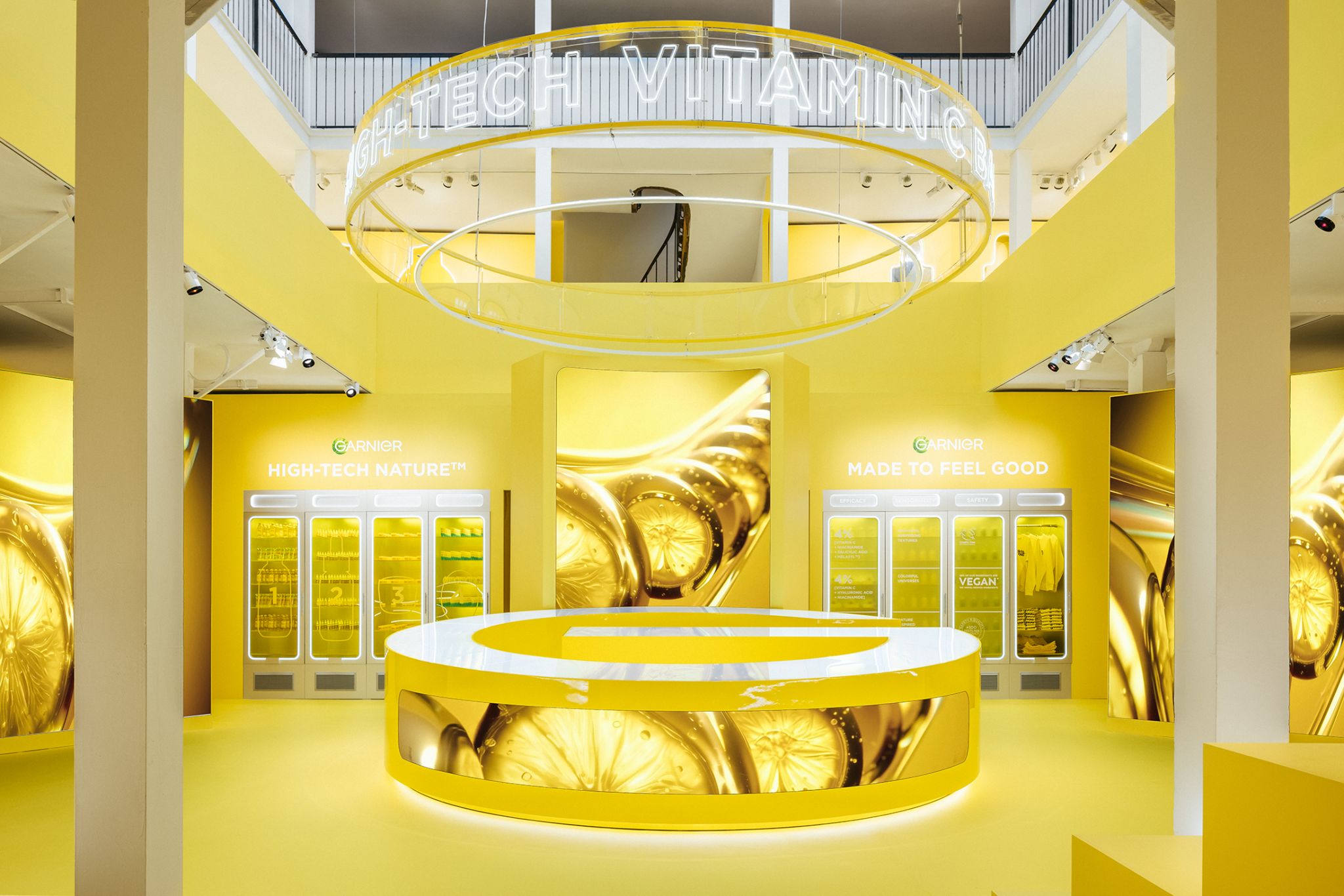 The completed Garnier pop-up with the circular counter, integrated displays and yellow brand environment.