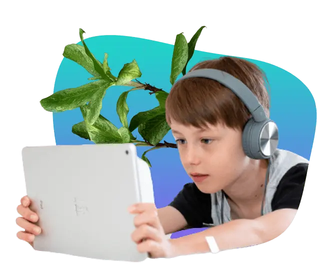 Young boy holding iPad and wearing headphones