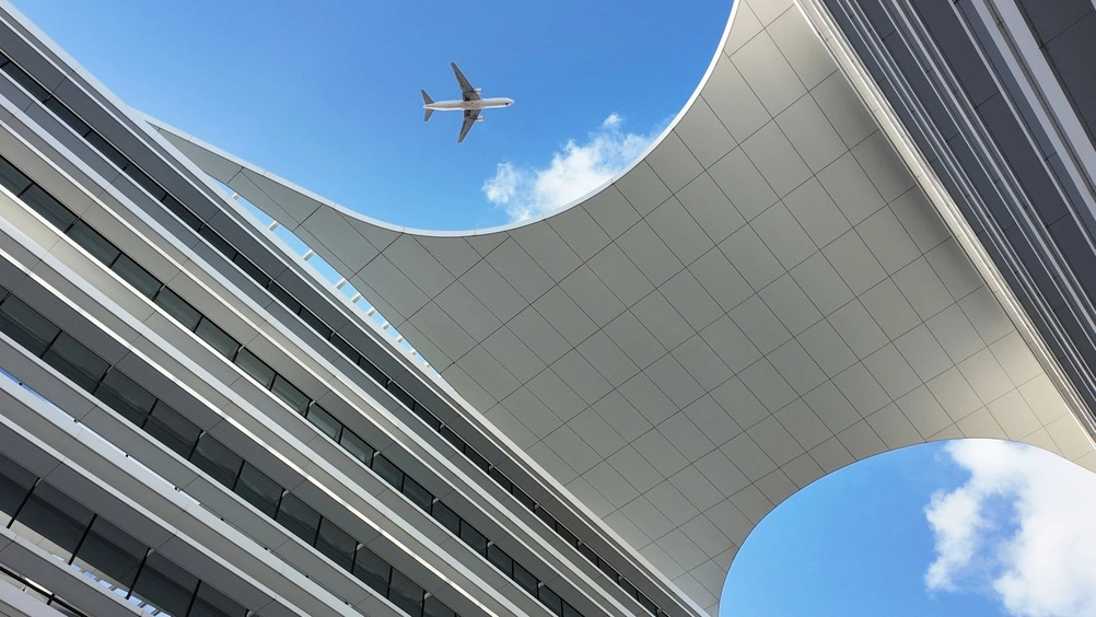 Plane flying over business district in Lisbon