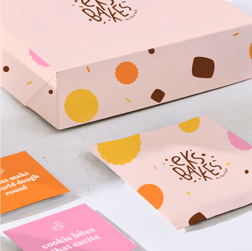 Pink bakery packaging with colorful circle and square patterns and 'ek's bakes' logo, alongside pink and orange cards with white text.
