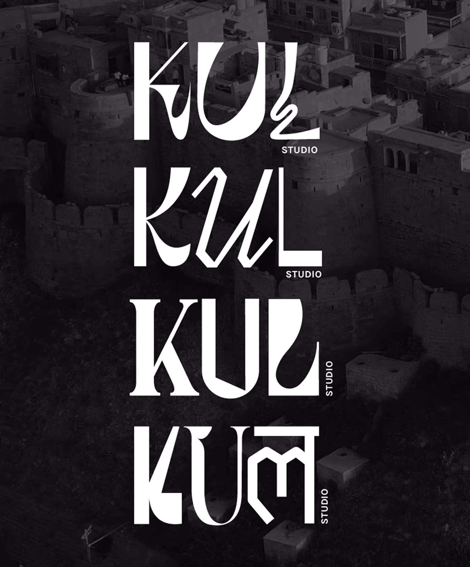 Four stylized white text logos reading 'KUL Studio' in varied artistic fonts on a dark aerial background of historic stone buildings.