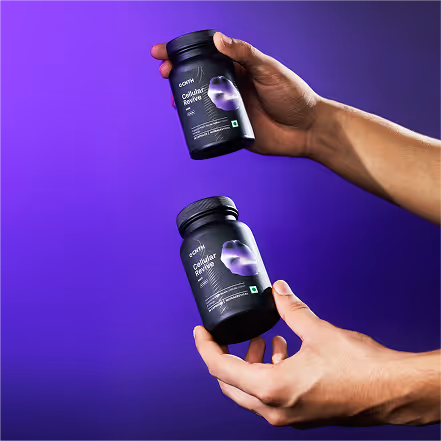 Two hands holding black bottles labeled 'Cellular Revive' against a purple gradient background.