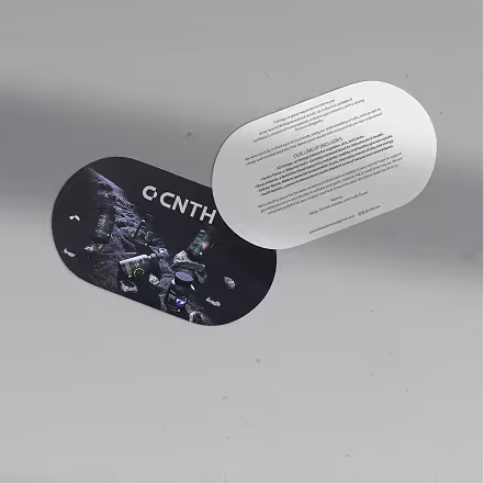 Two oval-shaped cards floating on a gray surface, one showing a dark image with text and knives, the other displaying text in a small font on a white background.