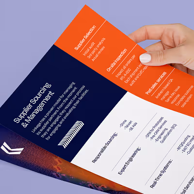 Close-up of a hand holding a brochure titled 'Supplier Sourcing & Management' with sections on supplier selection, onsite inspection, and post-audit site steps.