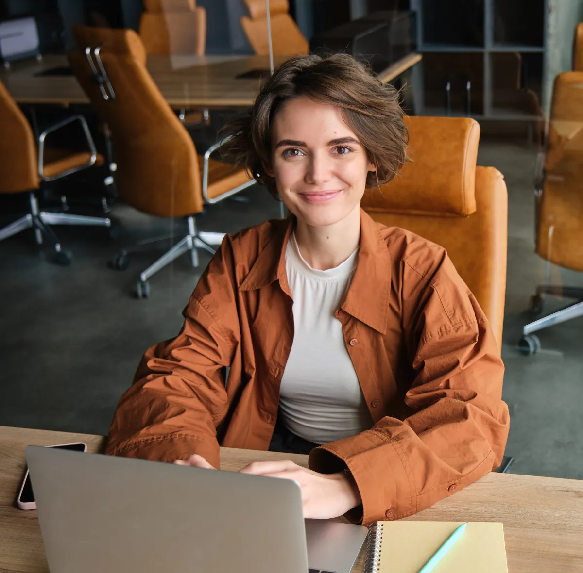Woman working in an office sitting with laptop
