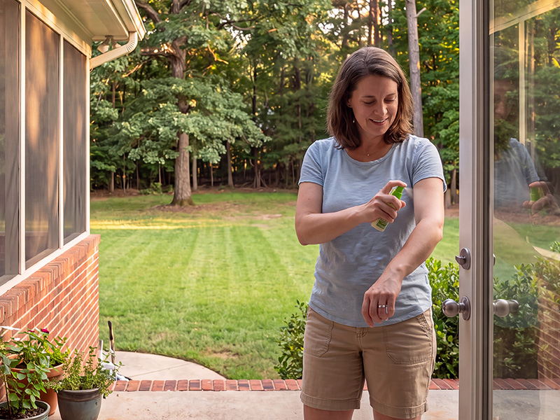 lady spraying bug spray