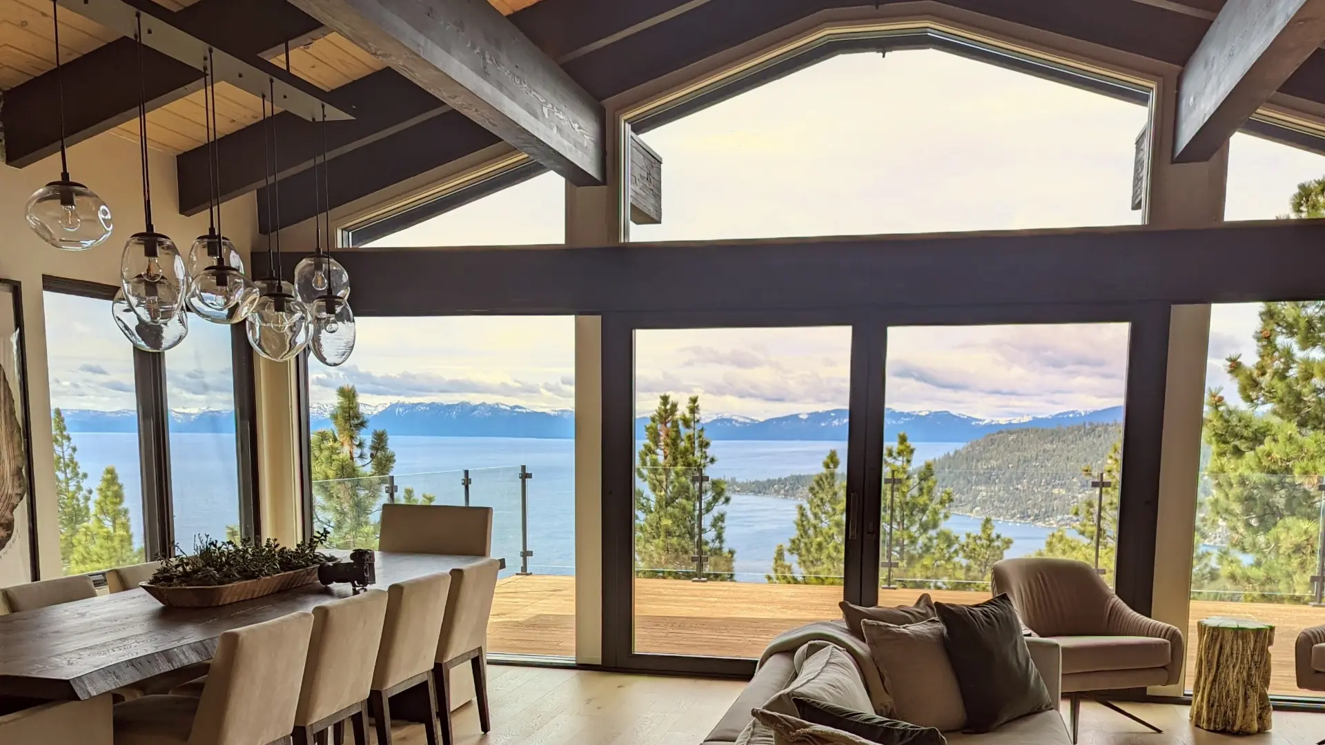 Lake Tahoe view from a living and dining area with exposed beams