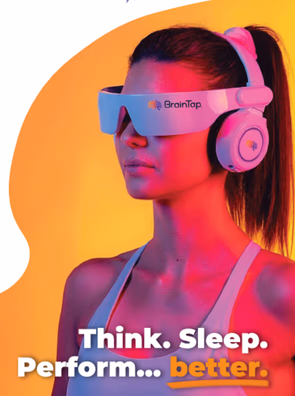 Person wearing BrainTap headset, bathed in pink and yellow light