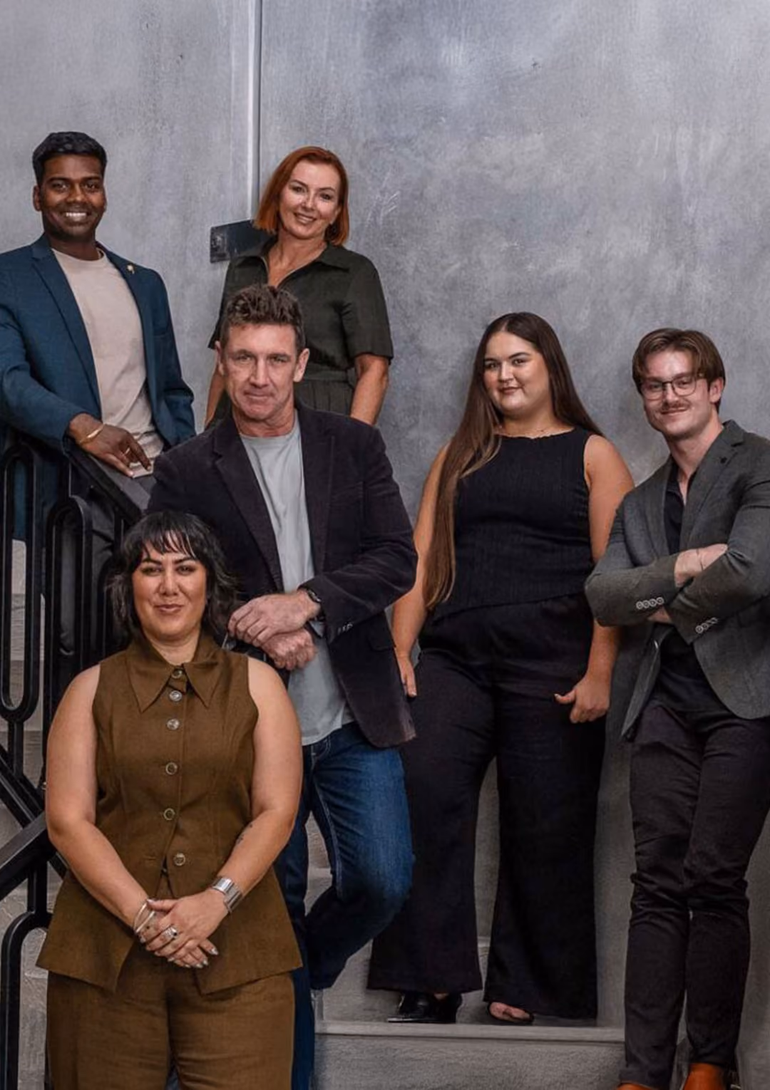 Real estate sales team portrait in modern office setting