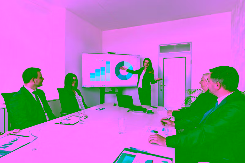 A group of people sitting around a conference table