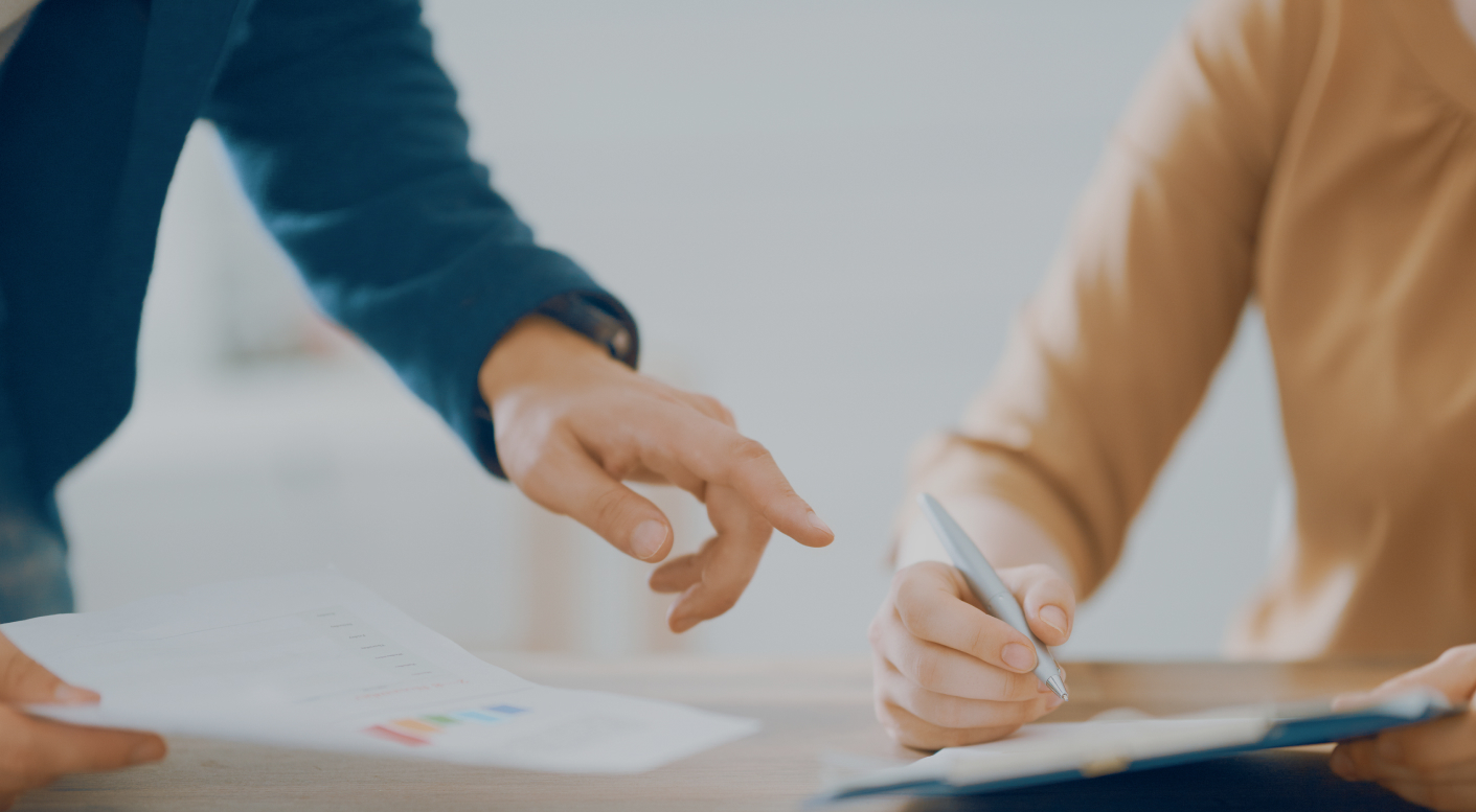 Two people signing a contract
