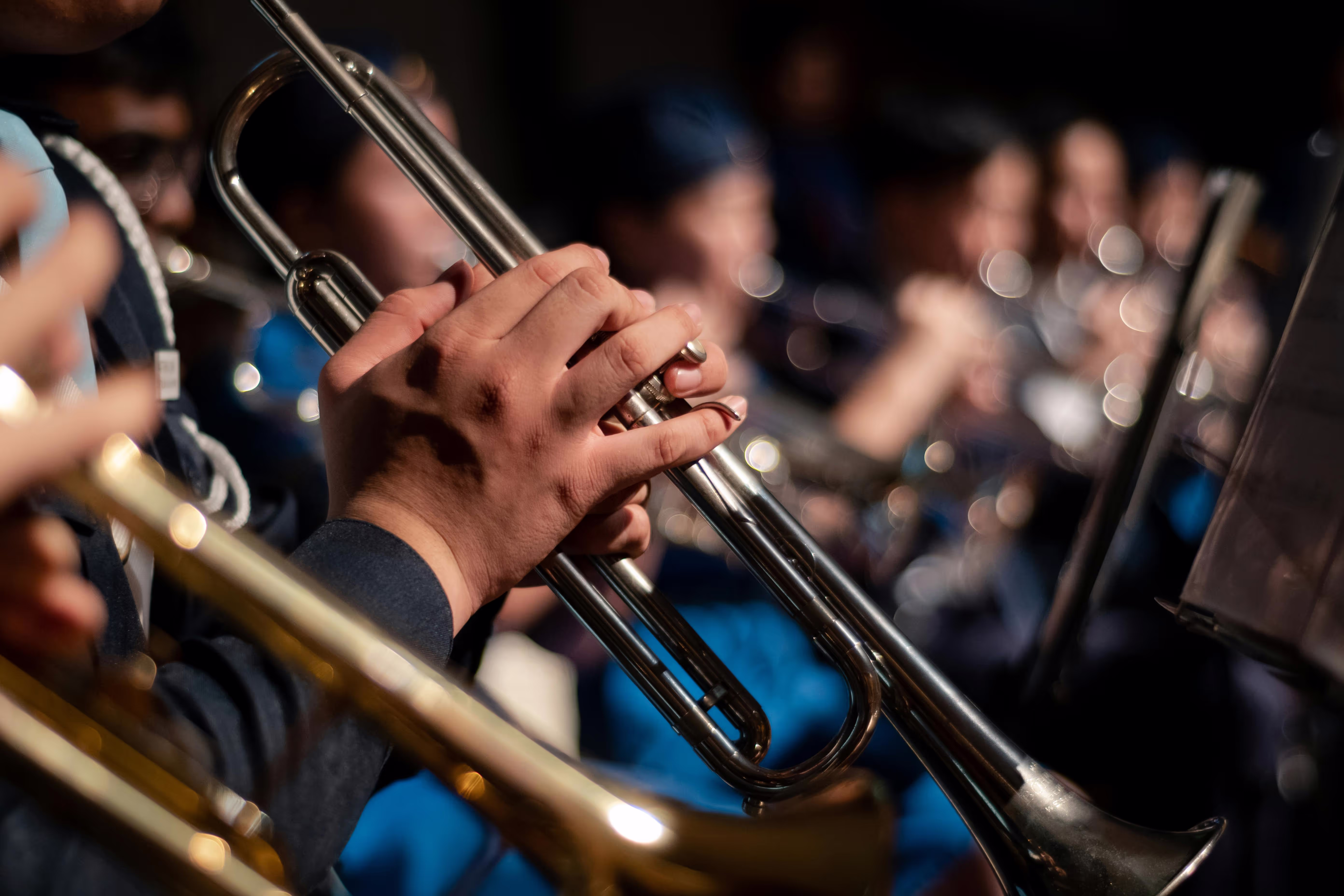 Picture of an orchestra showing mostly players who play the trumpet