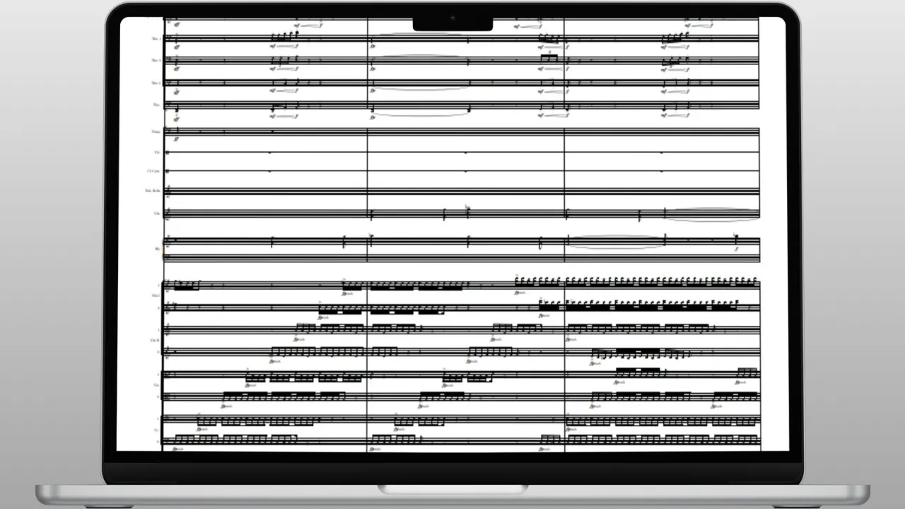 Laptop screen displaying a digital sheet music score with multiple musical staves and notes for various instruments.