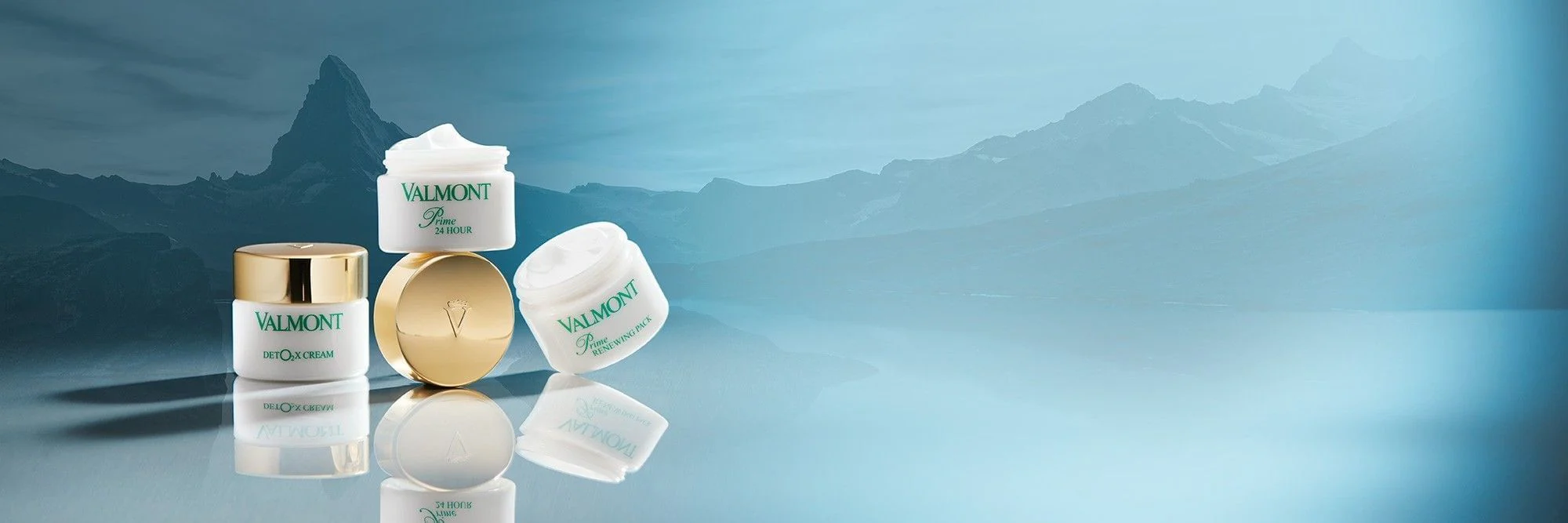 Valmont skincare reflected in an alpine lake