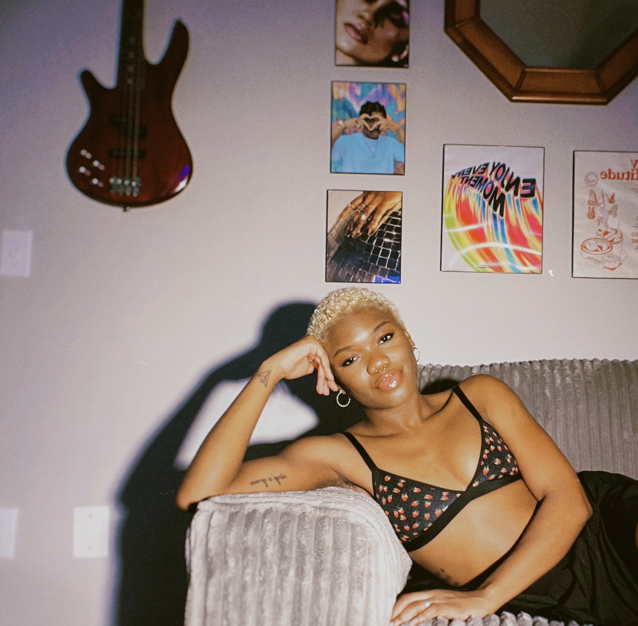 Beautiful black woman on a sofa with a dark bra