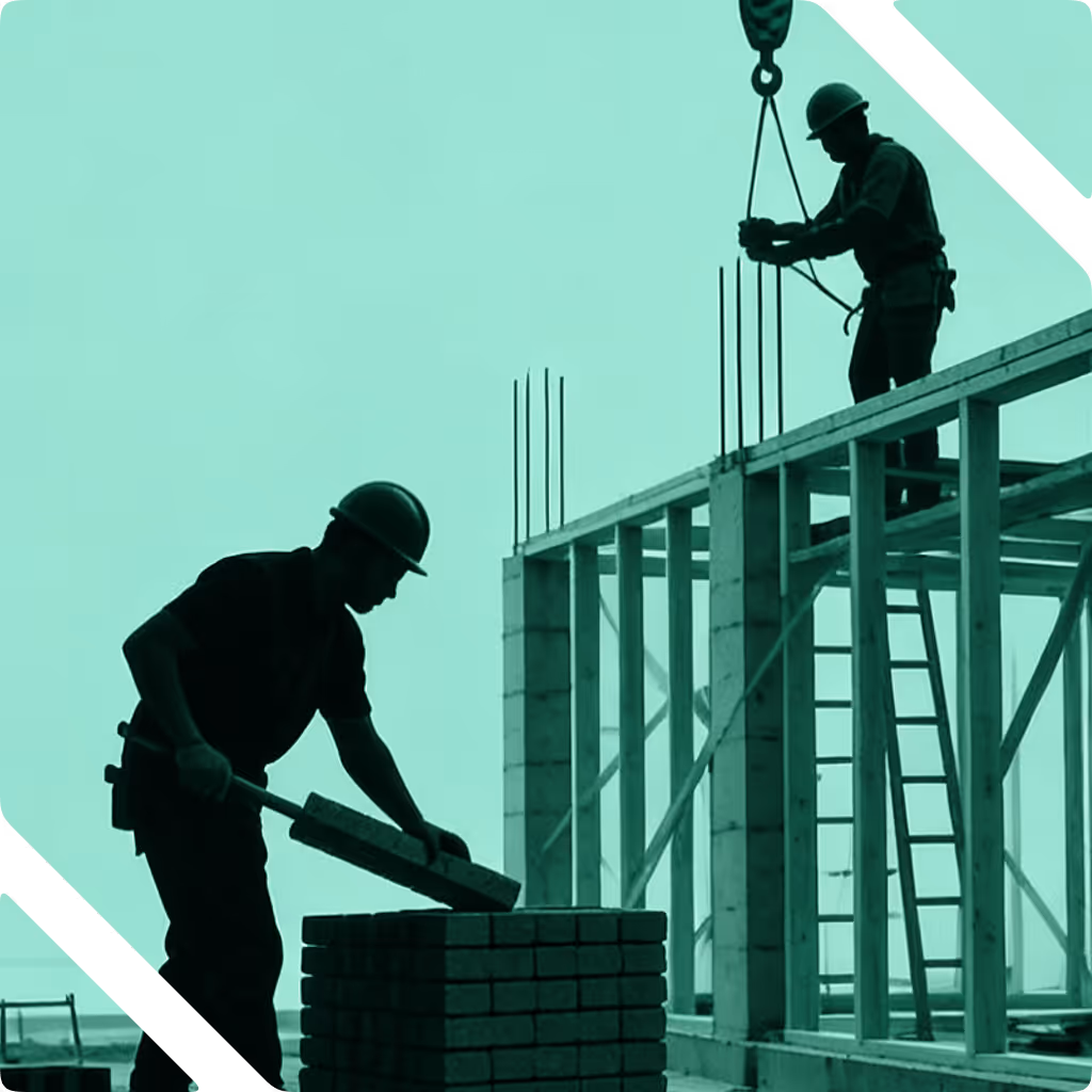 Silhouettes of two construction workers wearing helmets working on a building framework.