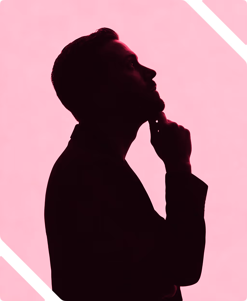 Silhouette of a man in profile holding his chin, set against a solid pink background.