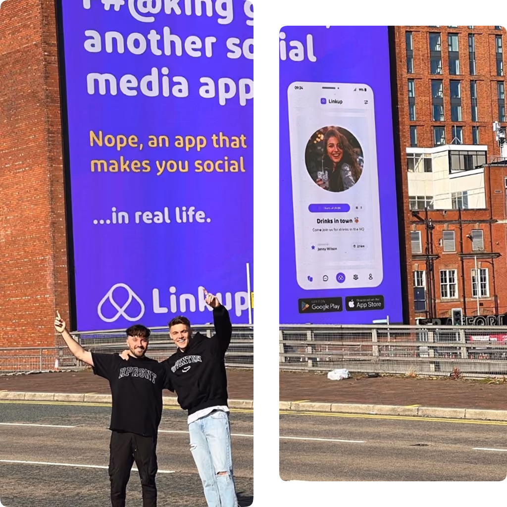 Two men smiling and posing with thumbs up in front of a Linkup app billboard on a city street.