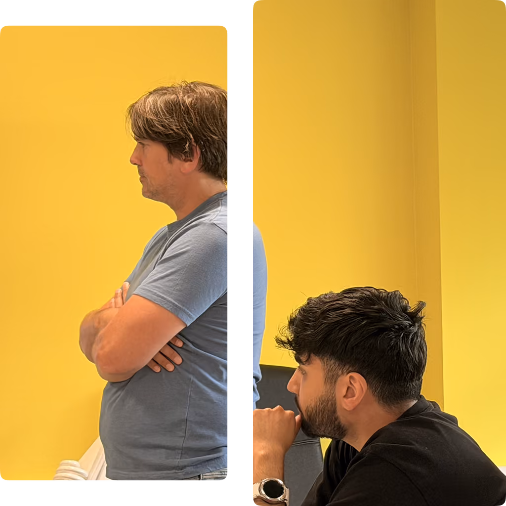 Two men looking thoughtfully to the left against a bright yellow wall background.