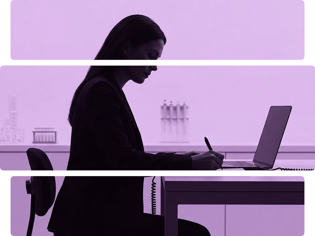 Silhouette of a woman sitting at a table, writing on a notepad next to an open laptop in a minimalist room.