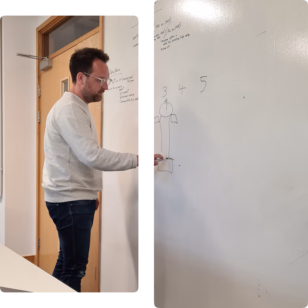 Man in glasses writing on a whiteboard with numbers 3, 4, and 5 and a simple diagram.