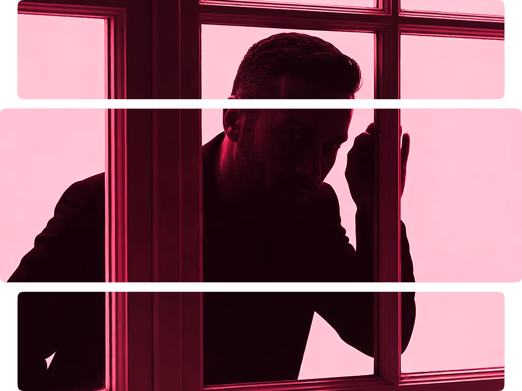 Silhouette of a man looking through a window framed by dark pink light.