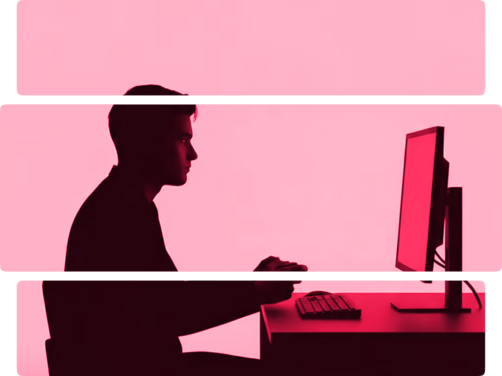 Silhouette of a man sitting at a desk using a computer with a pink background.
