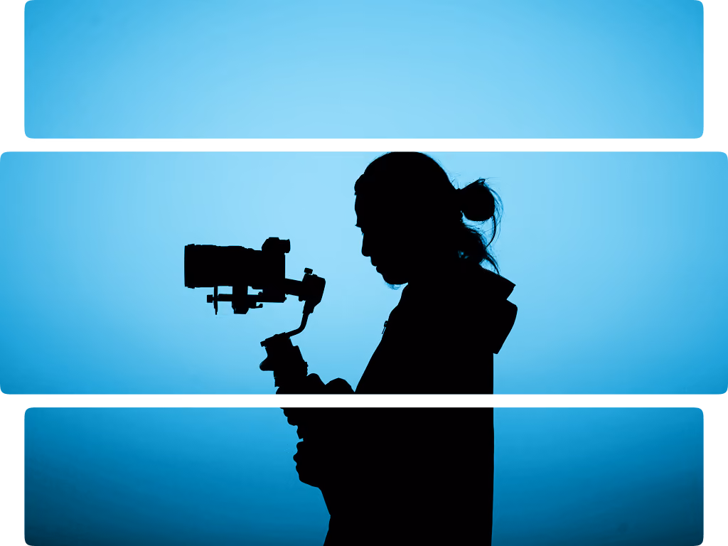 Silhouette of a person with a bun holding a camera on a stabilizer against a blue background.
