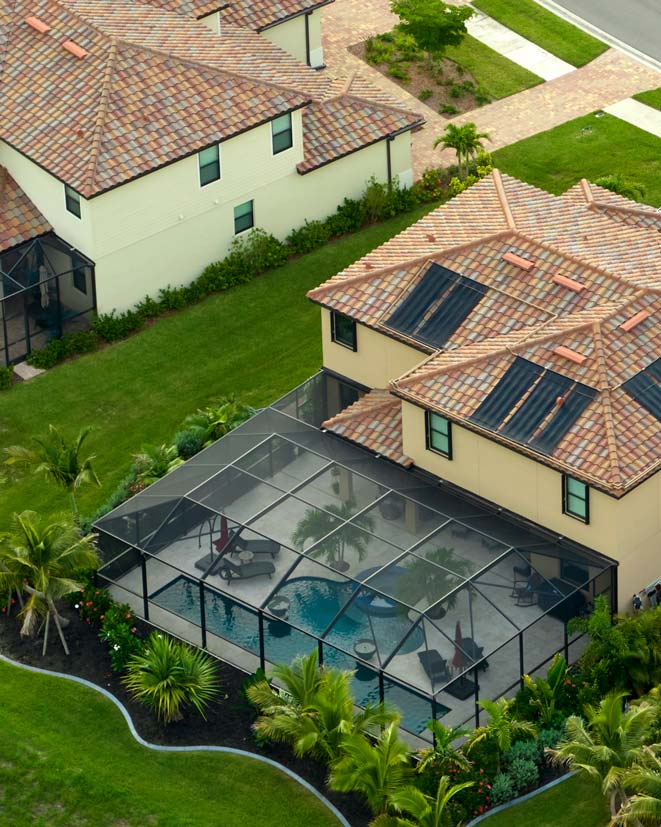 bird's-eye view of screened-in pool connected to home in neighborhood
