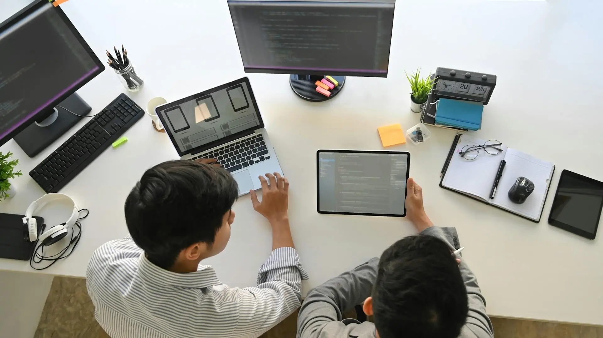 People reviewing a website interface and digital layouts