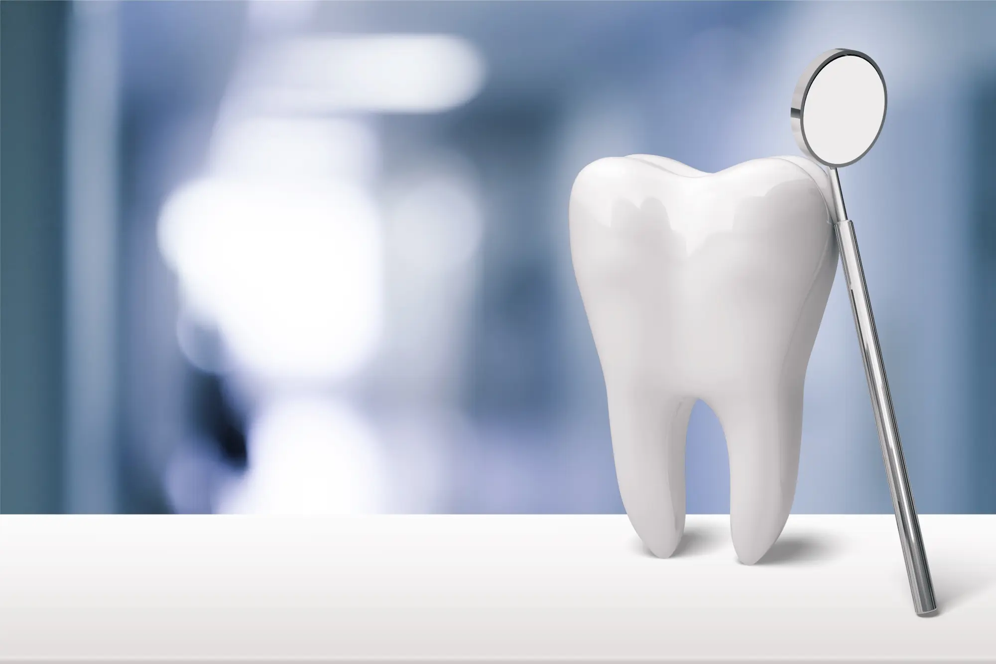 Tooth model beside a dental mirror
