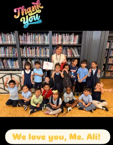 Students and teacher Ms Ali pose together in school library