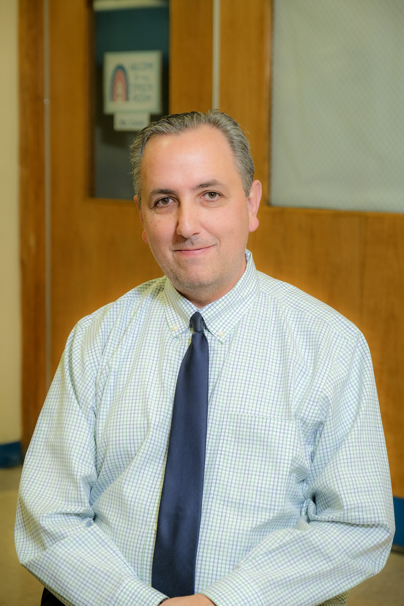 Joseph Martin staff member portrait in school hallway