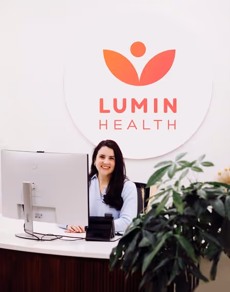 A friendly face at the Lumin Health front desk, greeting patients as they enter for their bespoke insurance-covered ketamine treatment and esketamine therapy with 5-star reviews and Harvard-trained doctors and physicians