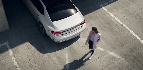 Woman walking behind Genesis G90