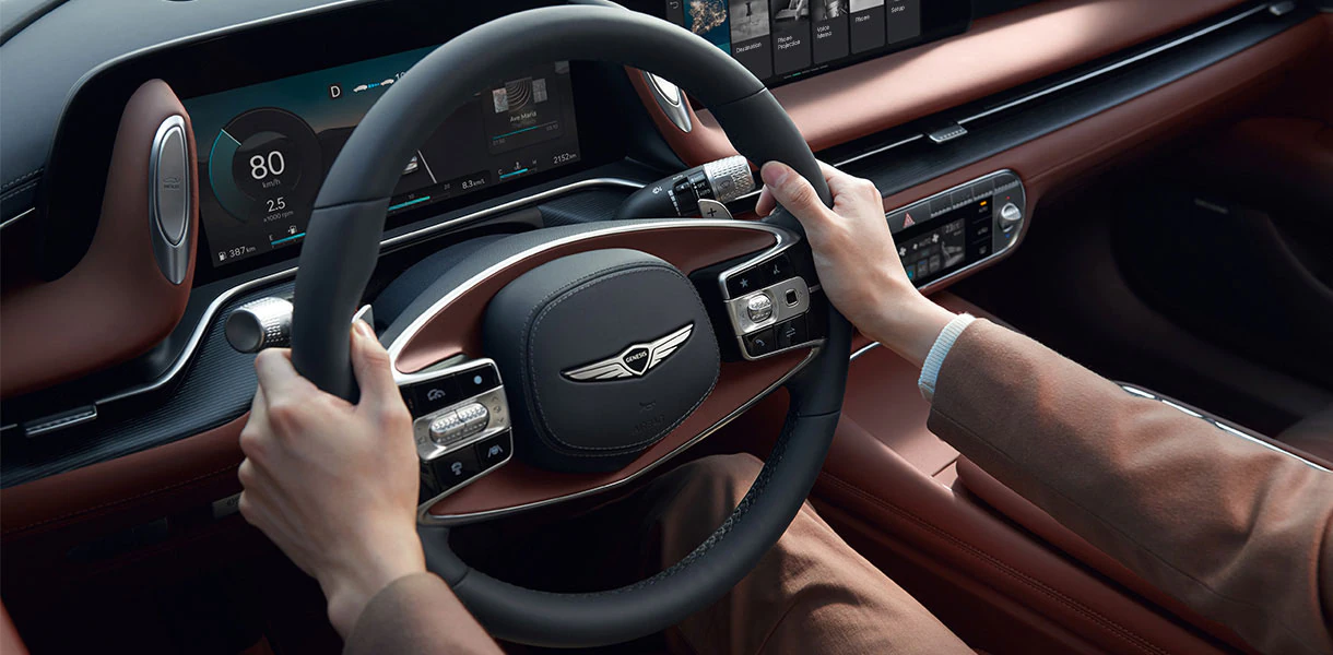 Close up view of two tone G90 steering wheel being operated by man