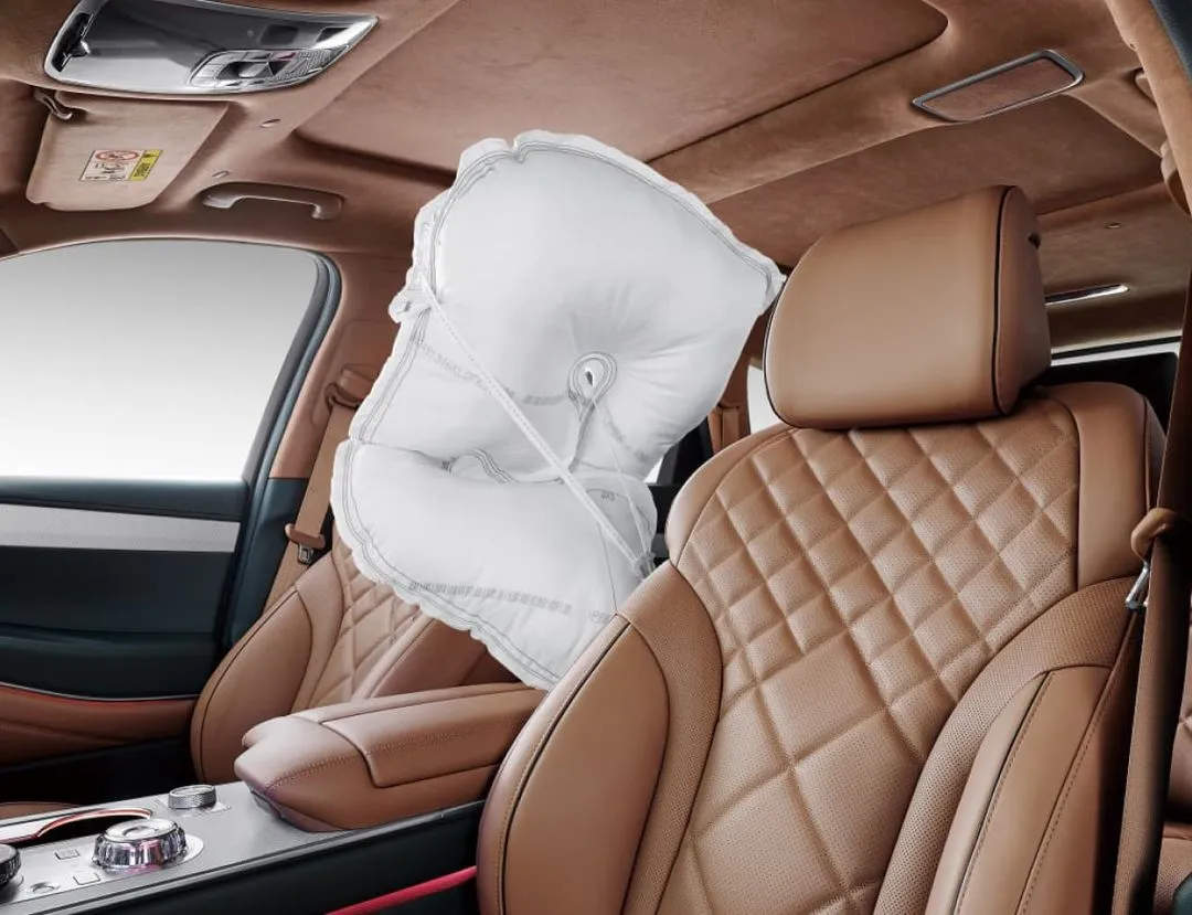 An airbag is seen between the driver's seat and the passenger seat.